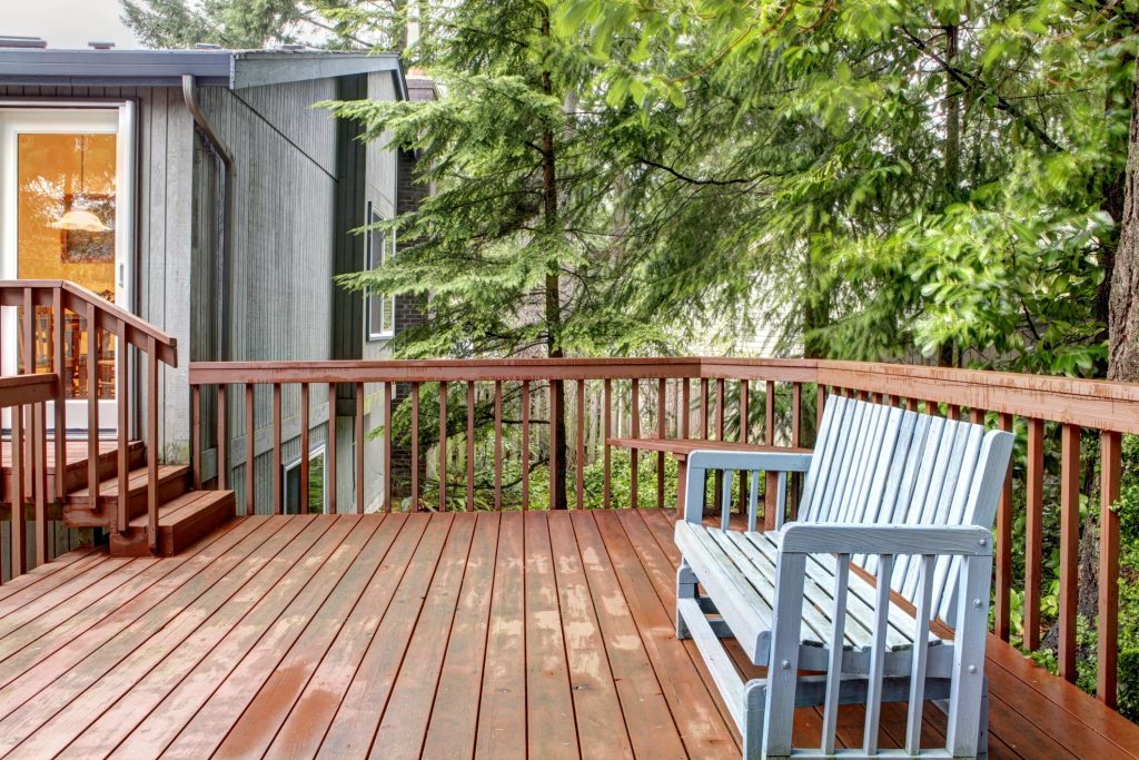 a wood deck with wood bench